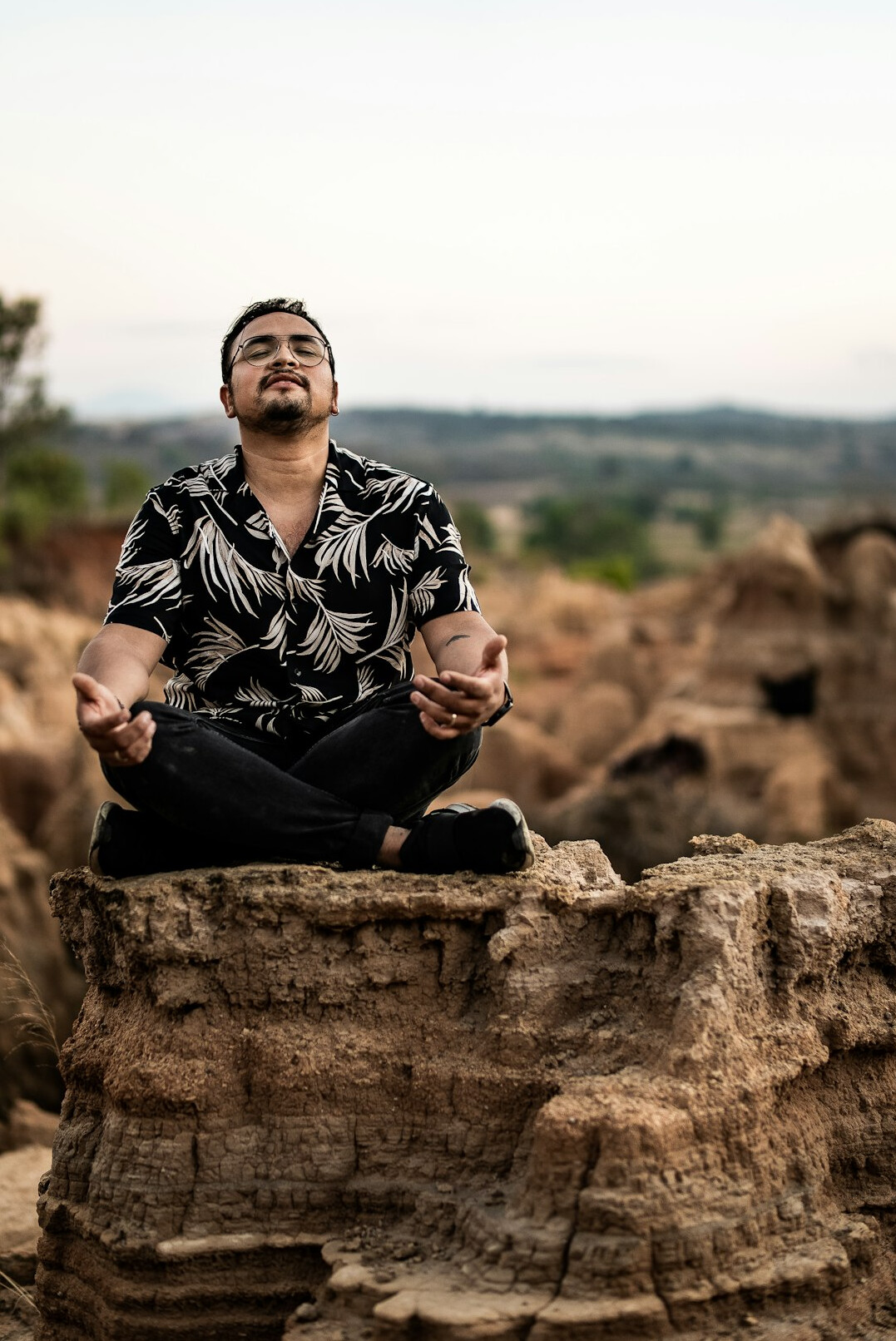 Man meditating in nature at sunrise